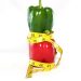 a red bell pepper wrapped in a measuring tape